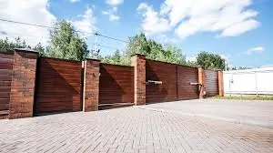 A long wooden automatic gate with multiple automation points, showcasing the premium Electric & Automatic Gates from Gates Wellington.