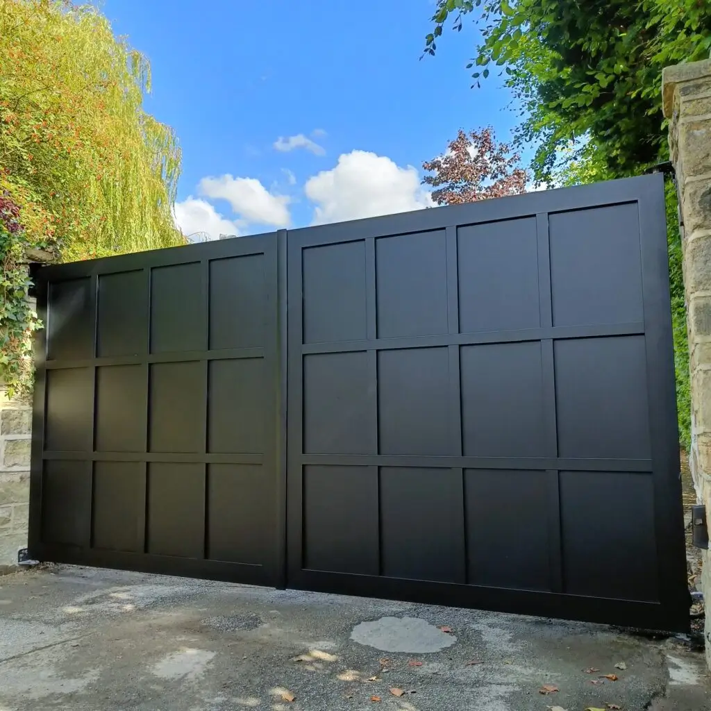 A solid black aluminium gate with a grid panel design, ensuring security and sophistication. Gates Wellington specializes in durable aluminium gates.