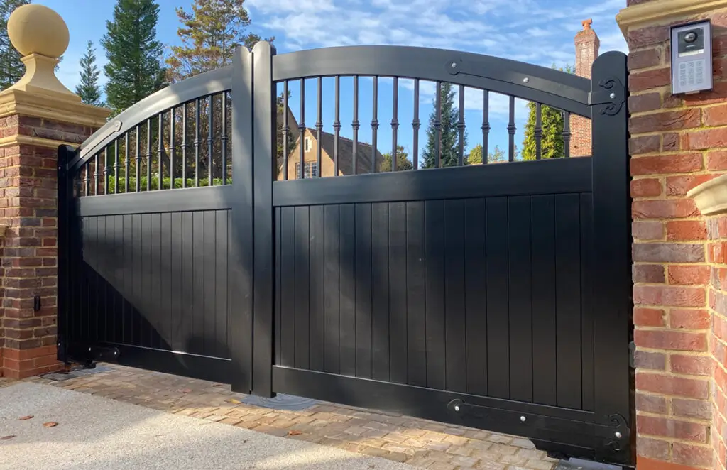 Elegant black double swing gate with vertical metal bars, creating a grand entrance, crafted by Gates Wellington.